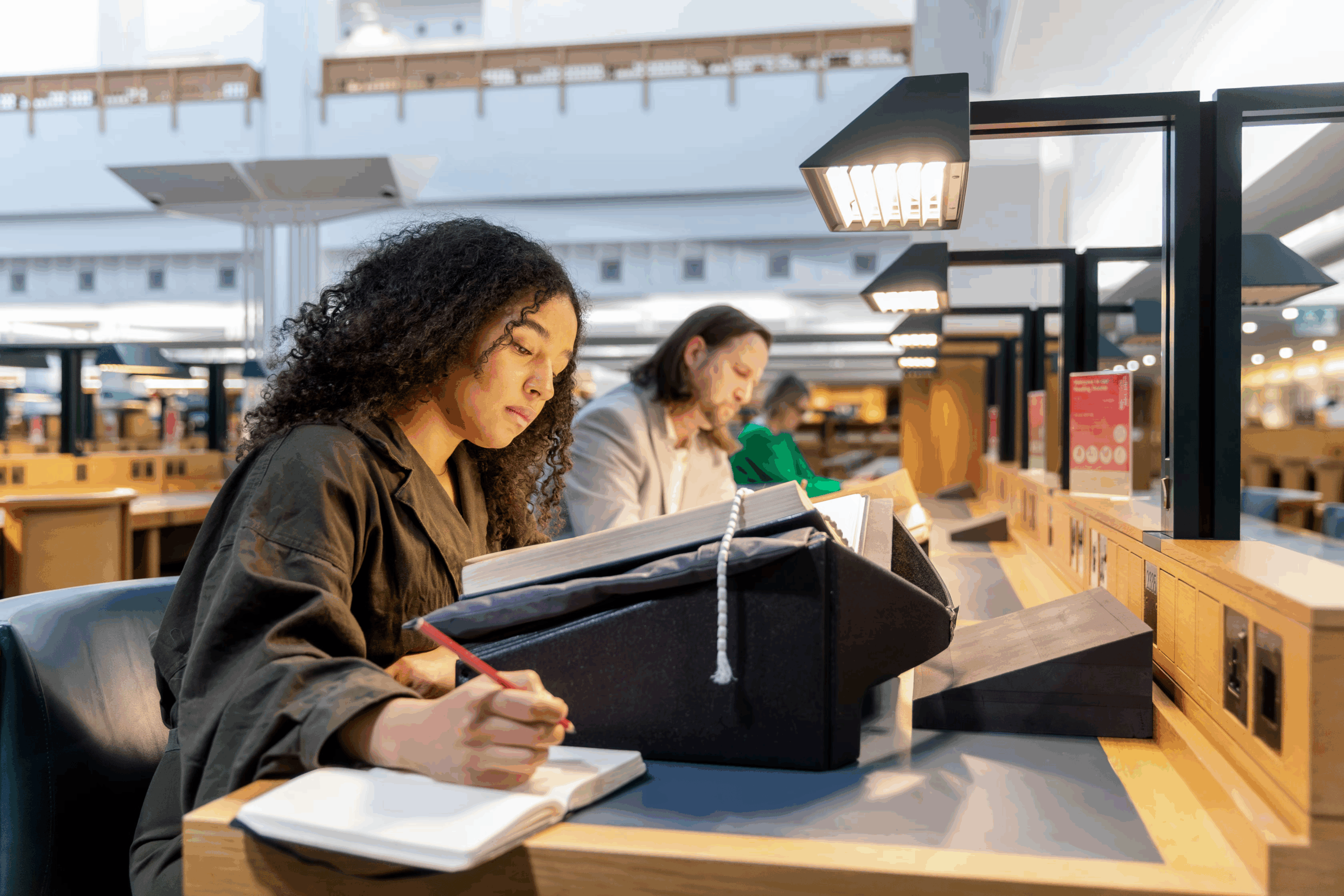 Smiling teenage girl reading a book